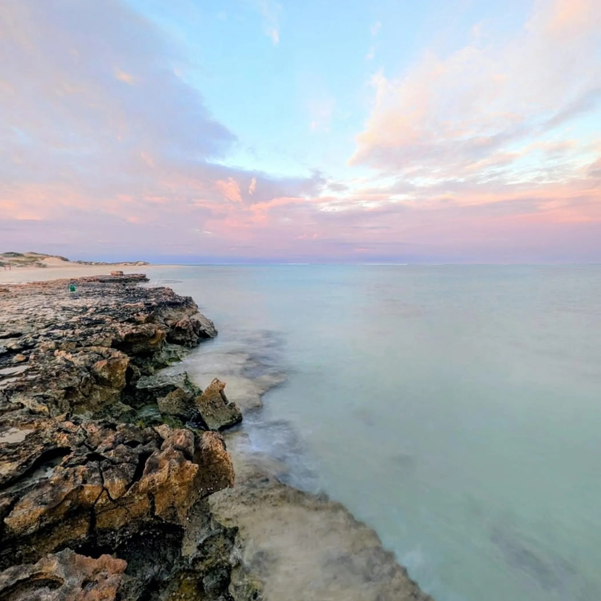 sandy beach with coral reef nearby